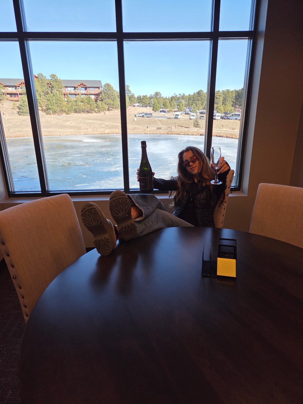 Olivia relaxing by the window overlooking a frozen mountain lake