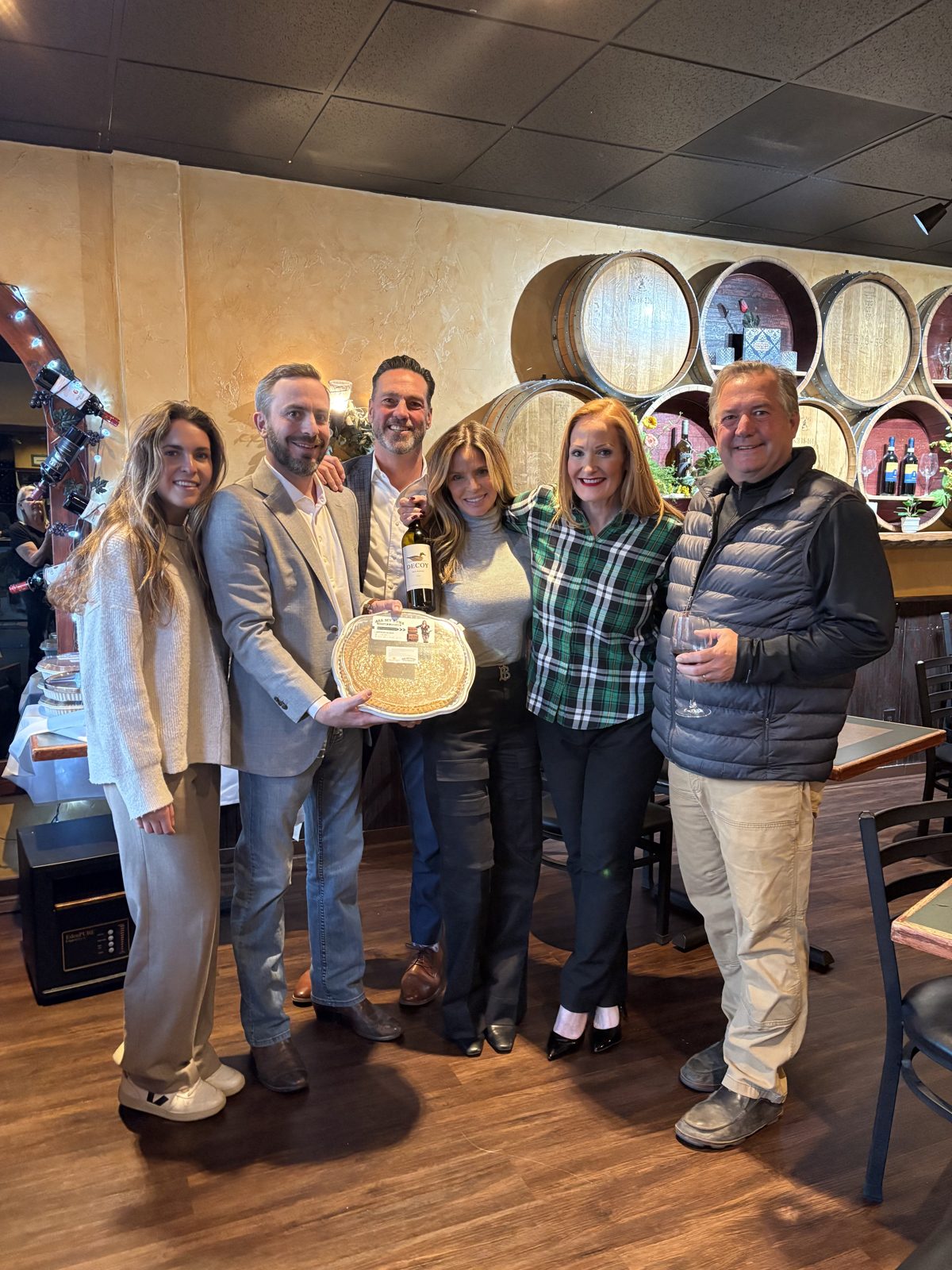 Olivia with realtors and partners celebrating at a winery
